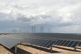 FILE - This June 15, 2021 photo shows a Public Service Co. of New Mexico solar farm west of Rio Rancho, N.M. The utility in sun-drenched New Mexico is struggling to get enough solar-generated electricity as it prepares to shut down a coal-fired power plant amid supply chain disruptions, one of the problems threatening to delay or cancel projects around the world amid pressure to reduce carbon emissions and tackle climate change. Public Service Co. of New Mexico initially proposed replacing the lost capacity with a mix of natural gas, solar and battery storage. The Public Regulation Commission instead opted for solar and storage to make up some of the difference after environmentalists pushed back on gas. (AP Photo/Susan Montoya Bryan, File)