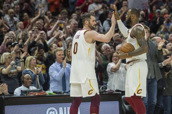 FILE - Cleveland Cavaliers' LeBron James, right, is congratulated by Kevin Love, after Jame's 867th consecutive game scoring in double figures during the first half of an NBA basketball game against the New Orleans Pelicans in Cleveland, Friday, March 30, 2018. James surpassed the old mark of 866 held by Michael Jordan. Cavaliers forward Love, in an essay for The Associated Press, reflected on his years as James' teammate. James is about to pass Kareem Abdul-Jabbar for the NBA career scoring record. (AP Photo/Phil Long, File)