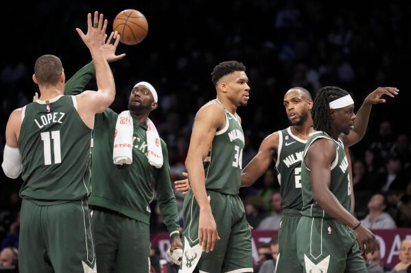 Milwaukee Bucks forward Giannis Antetokounmpo (34) celebrates with his teammates as they are substituted in the final minutes of the second half of an NBA basketball game against the Brooklyn Nets, Tuesday, Feb. 28, 2023, in New York. (AP Photo/John Minchillo)