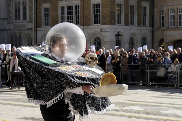 A runner competes during a traditional pancake race by livery companies at the Guildhall in London, Tuesday, March 4, 2025.(AP Photo/Frank Augstein)