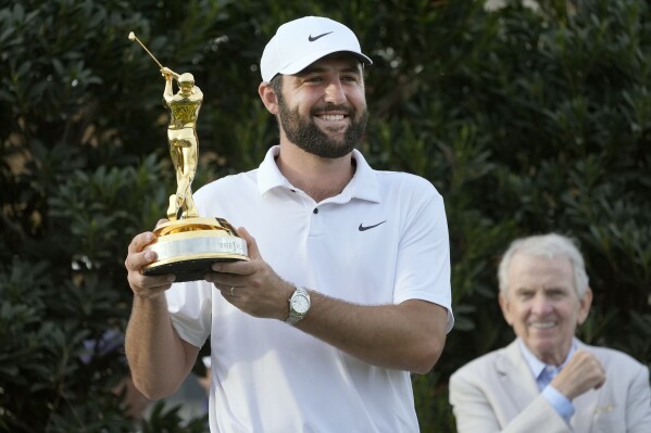 Scottie Scheffler celebrates after winning The Players Championship golf tournament Sunday, March 17, 2024, in Ponte Vedra Beach, Fla. (AP Photo/Marta Lavandier)