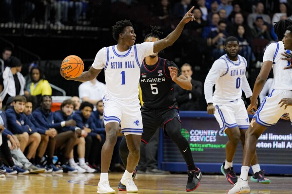 UConn guard Stephon Castle (5) defends as Seton Hall guard Kadary Richmond (1) motions to his teammates during the first half of an NCAA college basketball game against UConn in Newark, N.J., Wednesday, Dec. 20, 2023. (AP Photo/Peter K. Afriyie)