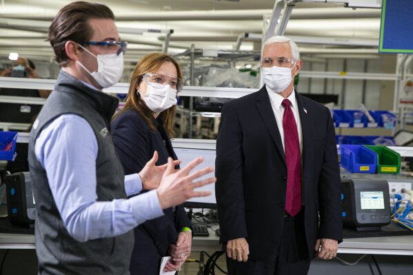 Vice President Mike Pence listens on a tour of the General Motors/Ventec ventilator production facility to Chris Kiple of Ventec along with GM CEO and Chairman Mary Barra in Kokomo, Ind., Thursday, April 30, 2020. (AP Photo/Michael Conroy)