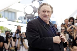 FILE - Actor Gerard Depardieu poses for photographers during a photo call for the film Valley of Love, at the 68th international film festival, Cannes, southern France, Friday, May 22, 2015. The Grevin Museum of waxworks in Paris has removed the wax figure of French actor Gerard Depardieu due to negative reactions from visitors, the museum said Monday. (AP Photo/Thibault Camus, File)