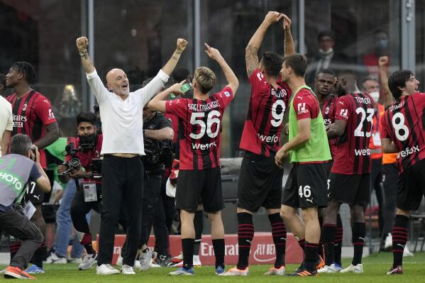 AC Milan's manager Stefano Pioli celebrates with the players at the end of the Serie A soccer match between AC Milan and Atalanta at the San Siro stadium, in Milan, Italy, Sunday, May 15, 2022. Milan won 2-0. (AP Photo/Antonio Calanni)