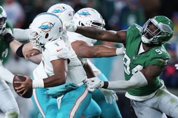 Philadelphia Eagles defensive end Josh Sweat (94) sacks Miami Dolphins quarterback Tua Tagovailoa (1) during the second half of an NFL football game Sunday, Oct. 22, 2023, in Philadelphia. (AP Photo/Matt Slocum)