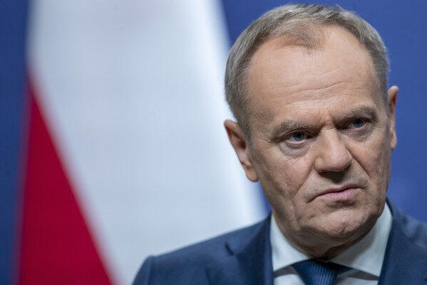 Poland's Prime Minister Donald Tusk pauses as he speaks, during a news conference following his meeting with Lithuania's Prime Minister Ingrida Simonyte at the government's headquarters in Vilnius, Lithuania, Monday, March 4, 2024. (AP Photo/Mindaugas Kulbis)
