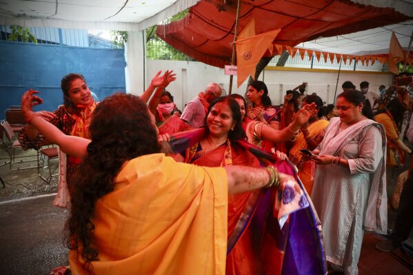Hindu women dance to celebrate ahead of a groundbreaking ceremony of a temple dedicated to the Hindu god Ram in Ayodhya, at the Vishwa Hindu Parishad, or World Hindu Council, headquarters in New Delhi, India, Wednesday, Aug. 5, 2020. The coronavirus is restricting a large crowd, but Hindus were joyful before Prime Minister Narendra Modi breaks ground Wednesday on a long-awaited temple of their most revered god Ram at the site of a demolished 16th century mosque in northern India. (AP Photo/Manish Swarup)