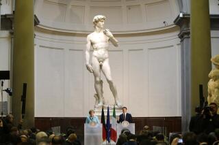 FILE - German Chancellor Angela Merkel, left, and Italian Prime Minister Matteo Renzi speak during a press conference in front of Michelangelo's "David statue" after their bilateral summit in Florence, Italy, Jan. 23, 2015. A Florida charter school principal has been forced to resign after a parent complained sixth graders were exposed to pornography during a lesson on Renaissance art that included Michelangelo’s “David” sculpture. (AP Photo/Antonio Calanni, File)