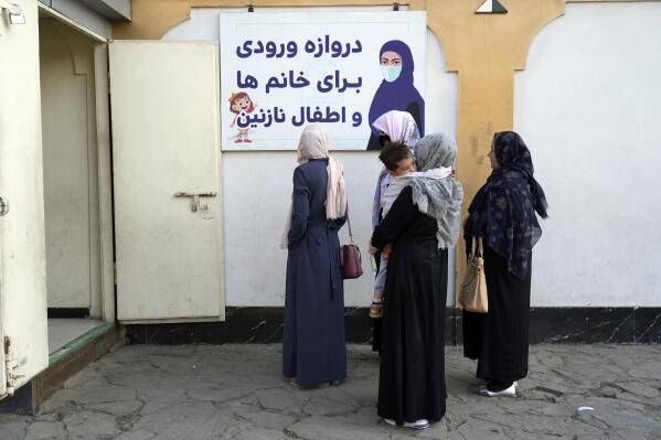 Afghan women stand outside an amusement park, in Kabul, Afghanistan, Thursday, Nov. 10, 2022.  The Taliban have banned women from using gyms and parks in Afghanistan, Thursday, Nov. 10. The rule, which comes into force this week, is the group's latest edict cracking down on women's rights and freedoms. (AP Photo/Ebrahim Noroozi)