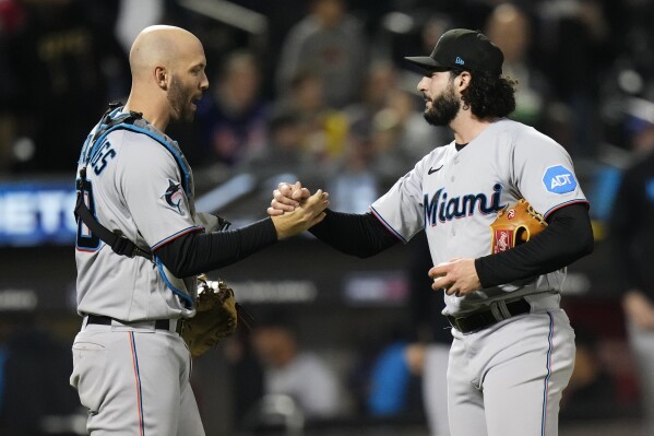 Miami Marlins catcher Jacob Stallings, left, celebrates with relief pitcher Andrew Nardi after the second baseball game of a doubleheader against the New York Mets, Wednesday, Sept. 27, 2023, in New York. (AP Photo/Frank Franklin II)