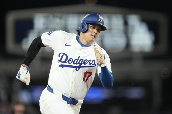 Los Angeles Dodgers designated hitter Shohei Ohtani rounds third on the way to scoring on a single by Will Smith during the seventh inning of a baseball game Friday, May 17, 2024, in Los Angeles. (AP Photo/Mark J. Terrill)