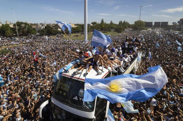 The Argentine soccer team that won the World Cup title ride on top of an open bus during their homecoming parade in Buenos Aires, Argentina, Tuesday, Dec. 20, 2022. (AP Photo/Rodrigo Abd)