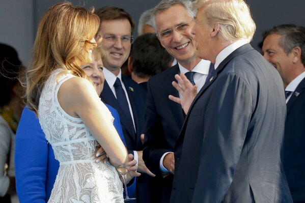 
              President Donald Trump, right, and first lady Melania Trump, left, talk with German Chancellor Angela Merkel second from the left and NATO Secretary General Jens Stoltenberg at the Parc du Cinquantenaire in Brussels, Belgium, Wednesday, July 11, 2018. (AP Photo/Pablo Martinez Monsivais)
            