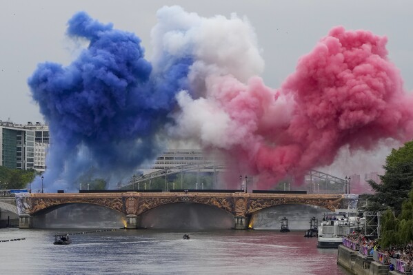 Ceremonial smoke within the colors of the France flag appear over the Seine River in Paris, France, all the method thru the hole ceremony of the 2024 Summer season Olympics, Friday, July 26, 2024. (AP Portray/Matthias Schrader)