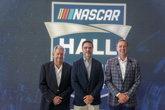 Donny Allison, left, Jimmie Johnson, center, and Chad Knaus pose for a picture after being selected into the NASCAR Hall of Fame on Wednesday, Aug. 2, 2023, in Charlotte, N.C. (AP Photo/Chris Carlson)