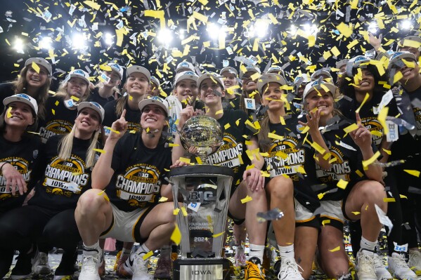 Iowa players and coaches celebrate after the overtime win against Nebraska of NCAA college basketball game in the final of the Big Ten women's tournament Sunday, March 10, 2024, in Minneapolis. (AP Photo/Abbie Parr)