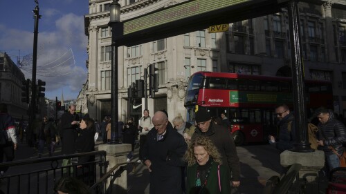 FILE - People walk along a street in a shopping district in central London, on Jan. 13, 2023. Wages in the U.K. are still rising at record highs, official figures showed Tuesday, July 11, 2023 as inflation remains stubbornly high. (AP Photo/Kin Cheung, File)