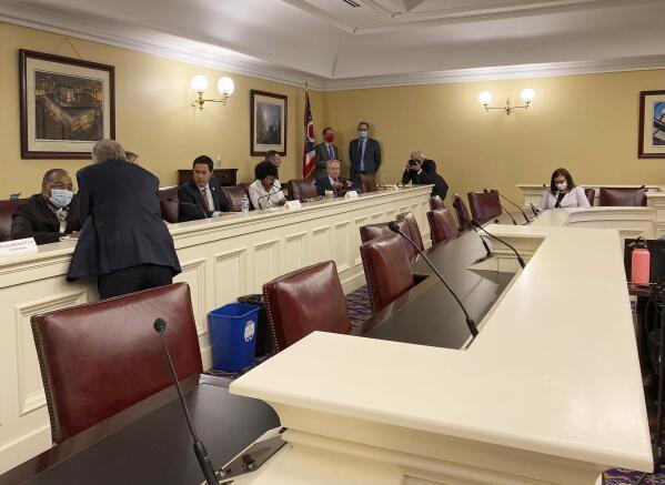 FILE - In this Sept. 15, 2021, photo, Republican Ohio Gov. Mike DeWine, foreground, speaks to state Sen. Vernon Sykes, seated, the co-chair of the Ohio Redistricting Commission, as other members of the panel prepare for a meeting on at the Ohio Statehouse in Columbus, Ohio. The GOP's focus on the makeup of state supreme courts escalated this week after a series of legal setbacks frustrated the party's effort to redraw congressional maps in Pennsylvania and North Carolina. That prompted some leading Republicans to press the party to pay more attention to elections in November in which some supreme court justices will face voters. (AP Photo/Julie Carr Smyth, File)