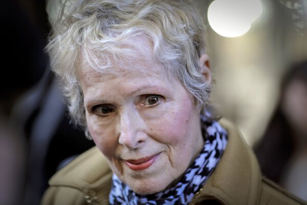 FILE - In this March 4, 2020, photo, E. Jean Carroll talks to reporters outside a courthouse in New York. The U.S. Justice Department is seeking to take over President Donald Trump's defense in a defamation lawsuit brought by Carroll, who accused the president of raping her in a New York luxury department store in the mid-1990s. Federal lawyers asked a court Tuesday, Sept. 8, 2020, to allow a legal move that could put the American people on the hook for any money she might be awarded. She says the president's comments, including that she was “totally lying” to sell a memoir, besmirched her character and harmed her career when he denied the rape allegations in 2019. (AP Photo/Seth Wenig, File)