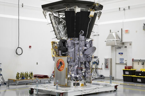 
              This July 6, 2018 photo made available by NASA shows the Parker Solar Probe in a clean room at Astrotech Space Operations in Titusville, Fla., after the installation of its heat shield. NASA's Parker Solar Probe will be the first spacecraft to "touch" the sun, hurtling through the sizzling solar atmosphere and coming within just 3.8 million miles (6 million kilometers) of the surface. (Ed Whitman/Johns Hopkins APL/NASA via AP)
            