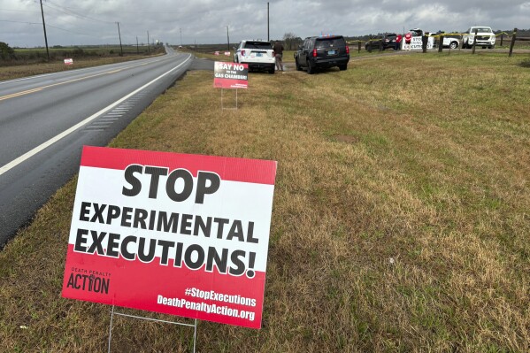 FILE - Anti-death penalty signs placed by activists stand along the road heading to Holman Correctional Facility in Atmore, Ala., ahead of the scheduled execution of Kenneth Eugene Smith, Thursday, Jan. 25, 2024. On Thursday, Alabama put Smith to death with nitrogen gas. (AP Photo/Kim Chandler, File)