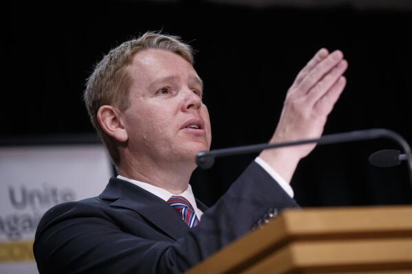 New Zealand's COVID-19 Response Minister Chris Hipkins gestures during a press conference in Wellington, New Zealand, Thursday, Oct. 28, 2021. Hipkins said that from next month, most people arriving in New Zealand would need to spend seven days in a quarantine hotel run by the military, half the previous requirement. (Robert Kitchin/Pool Photo via AP)