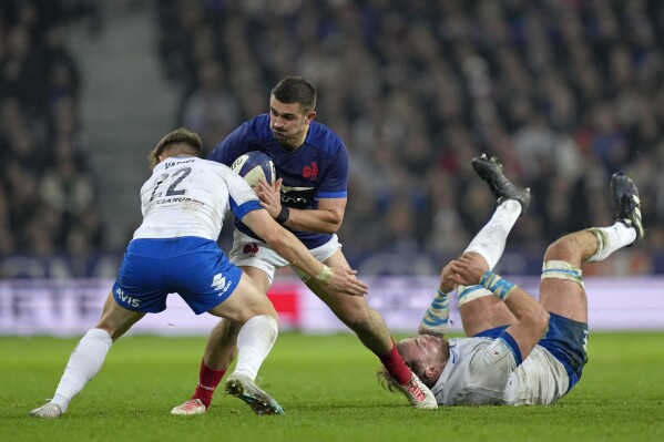 France's Thomas Ramos is challenged by Italy's Stephen Varney during the Six Nations rugby union international between France and Italy at the Pierre Mauroy stadium in Villeneuve d'Ascq, northern France, Sunday, Feb. 25, 2024. (AP Photo/Lewis Joly)