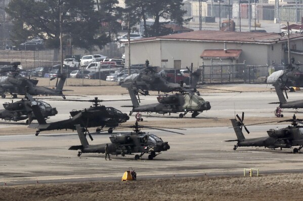 U.S. Army Apache helicopters take off at Camp Humphreys in Pyeongtaek, South Korea, Monday, March 4, 2024. North Korea called the ongoing South Korean-U.S. military drills a plot to invade the country, as it threatened Tuesday to take unspecified "responsible" military steps in response. (Kwon June-woo/Yonhap via AP)