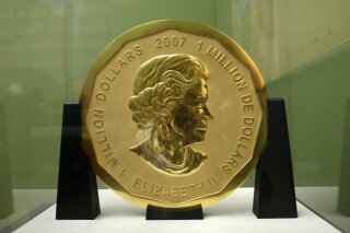 FILE - The Dec. 12, 2010 file photo shows the gold coin 'Big Maple Leaf' in the Bode Museum in Berlin. The 100-kilogram (220 pound) gold coin disappeared from the museum. (Marcel Mettelsiefen/dpa via AP)