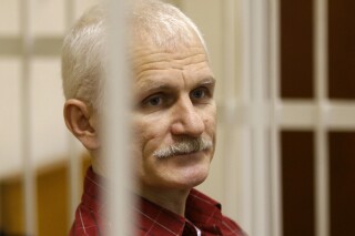 FILE - Ales Bialiatski, the head of Belarusian Viasna rights group, stands in a defendants' cage during a court session in Minsk, Belarus, on Nov. 2, 2011. Belarusian authorities Wednesday Aug. 23, 2023 declared the country's oldest and most prominent human rights group an extremist organization. The move against Viasna, founded by imprisoned Nobel Peace Prize laureate Ales Bialiatksi, comes amid a yearslong crackdown on dissent in Belarus and exposes anyone involved in its activities to criminal prosecution. (AP Photo/Sergei Grits, File)
