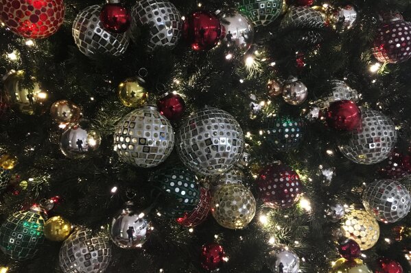
              In this Friday, Dec. 1, 2017, photo, ornaments hang on a Christmas tree on display in New York. The office holiday party is getting shaken up as reports of sexual misconduct by famous and powerful men have many companies thinking harder about how to stop bad behavior in the workplace. A survey shows fewer companies will serve alcohol this year than last year, but HR experts say that’s not enough. (AP Photo/Swayne B. Hall)
            