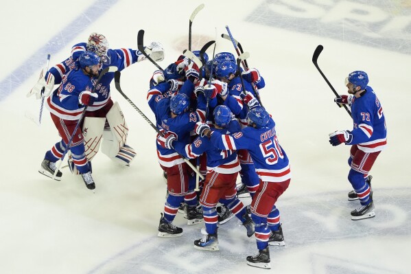 The New York Rangers celebrate after beating the Florida Panthers in overtime of Game 2 during the Eastern Conference finals of the NHL hockey Stanley Cup playoffs, Friday, May 24, 2024, in New York. (AP Photo/Julia Nikhinson)