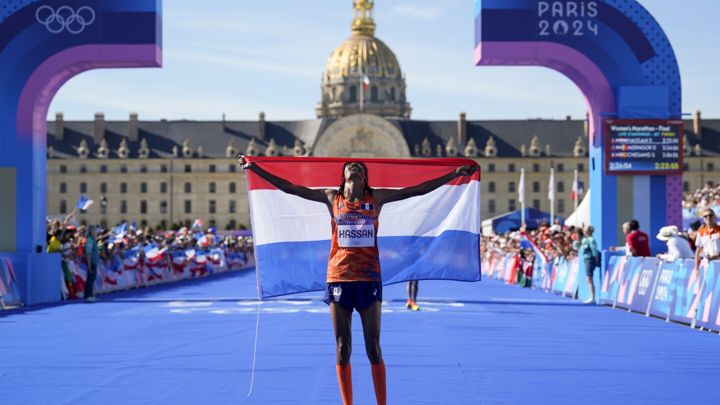 Sifan Hassan, of the Netherlands, celebrates after crossing the finish line to win the gold medal at the end of the women's marathon competition at the 2024 Summer Olympics, Sunday, Aug. 11, 2024, in Paris, France. (AP Photo/Vadim Ghirda)