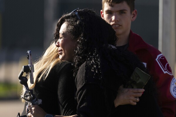 Women embrace after a news conference where law enforcement officials announced that the body of 11-year-old Audrii Cunningham was found in the Trinity River near her home in Livingston, Texas, Tuesday, Feb. 20, 2024, in Livingston. (Jason Fochtman/Houston Chronicle via AP)