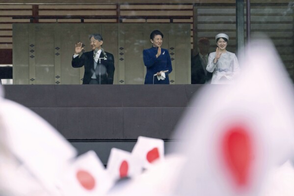 Japan's Emperor Naruhito, left, Empress Masako, center, and their daughter Princess Aiko wave to well-wishers, from the balcony of the Imperial Palace in Tokyo on Friday, Feb. 23, 2024. Naruhito turns 64 on Friday. (Tomohiro Ohsumi/Pool Photo via AP)