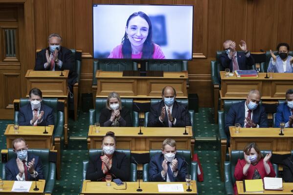 New Zealand Prime Minister Jacinda Ardern receives a applause from colleagues after her address to parliament via a video link as she isolates at home after catching COVID-19 in Wellington, New Zealand, Thursday, May 19, 2022. New Zealand's government said Thursday it will hand out an extra few hundred dollars to about half of all adults to help them navigate what it describes as "the peak of the global inflation storm." (Mark Mitchell/NZ Herald via AP)