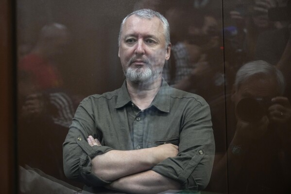 Igor Girkin also know as Igor Strelkov, the former military chief for Russia-backed separatists in eastern Ukraine sits in a glass cage in a courtroom at the Moscow's Meshchansky District Court in Moscow, Russia, Friday, July 21, 2023. A prominent Russian hard-line nationalist who accused President Vladimir Putin of weakness and indecision in Ukraine was detained Friday on charges of extremism, a signal the Kremlin has toughened its approach with hawkish critics after last month's abortive rebellion by the Wagner mercenary company. (AP Photo/Alexander Zemlianichenko, Pool)