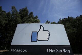 FILE - In this April 14, 2020 file photo, the thumbs up Like logo is shown on a sign at Facebook headquarters in Menlo Park, Calif. Facebook said Tuesday, Sept. 1 that it removed a small network of accounts and pages linked to Russia's Internet Research Agency, the “troll factory" that has used social media accounts to sow political discord in the U.S. since the 2016 presidential election. (AP Photo/Jeff Chiu, File)