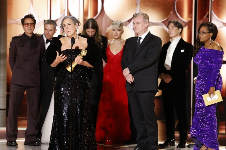 This image released by CBS shows producer Emma Thomas, foreground left, accepting the award for best motion picture drama for "Oppenheimer" as cast and crew members look on during the 81st Annual Golden Globe Awards in Beverly Hills, Calif., on Sunday, Jan. 7, 2024. (Sonja Flemming/CBS via AP)