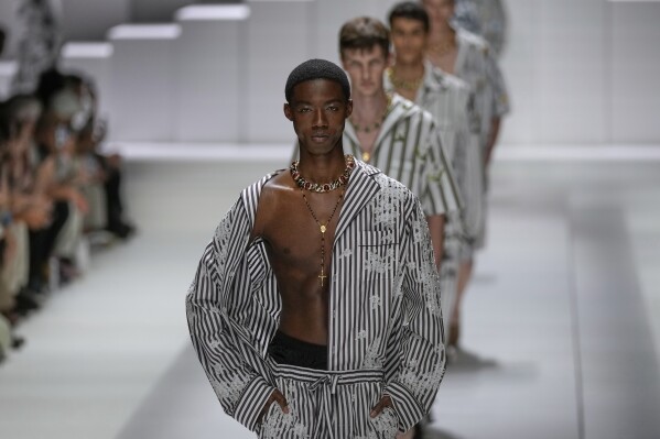 Models wear creations as part of the men's Dolce & Gabbana Spring-Summer 2026 collection, that was presented in Milan, Italy, Saturday, June 21, 2025. (AP Photo/Luca Bruno)