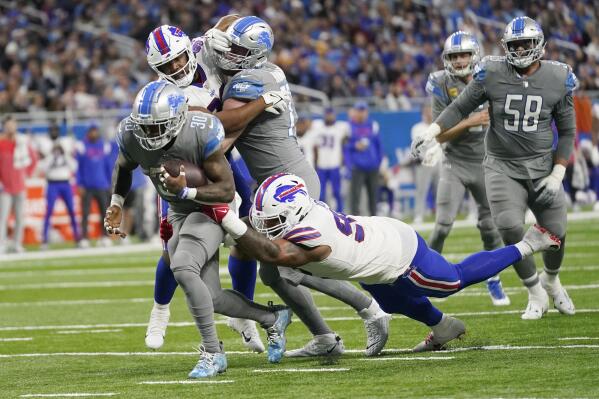 Detroit Lions running back D'Andre Swift (32) is tackled by Buffalo Bills  linebacker A.J. Klein (52) in the second half during an NFL football game,  Thursday, Nov. 24, 2022, in Detroit. (AP