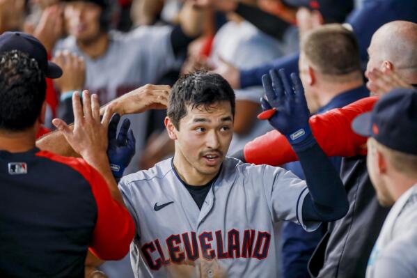 Cleveland Guardians' Steven Kwan celebrates with teammates in the dugout after hitting a grand slam during the eighth inning of a baseball game against the Texas Rangers in Arlington, Texas, Sunday, Sept. 25, 2022. (AP Photo/Gareth Patterson)
