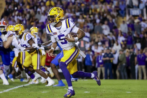 LSU quarterback Jayden Daniels (5) runs for a touchdown against Florida during the first half of an NCAA college football game in Baton Rouge, La., Saturday, Nov. 11, 2023. (AP Photo/Derick Hingle)