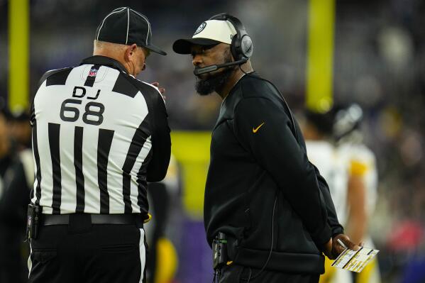 Pittsburgh Steelers head coach Mike Tomlin speaks with down judge Tom Stephan in the first half of an NFL football game against the Baltimore Ravens in Baltimore, Sunday, Jan. 1, 2023. (AP Photo/Julio Cortez)