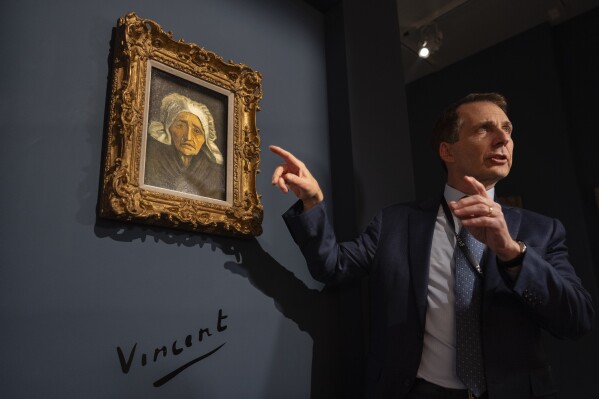 Bill Rau, president of M.S. Rau gallery, is interviewed next to Dutch master Vincent van Gogh's painting titled 