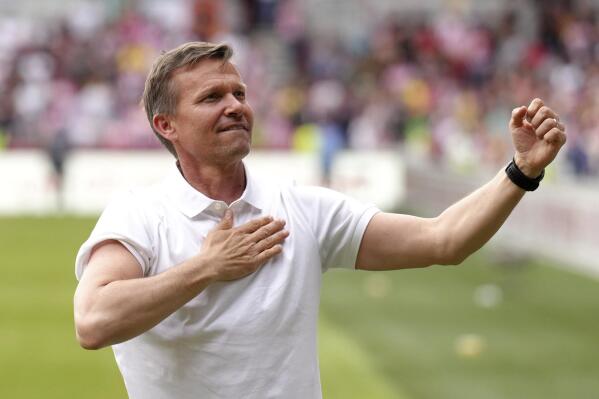 Leeds United manager Jesse Marsch celebrates survival with the fans after the English Premier League soccer match between Brentford and Leeds United, at the Brentford Community Stadium, in London, Sunday, May 22, 2022. (John Walton/PA via AP)