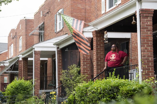 Makia Green stands outside her Washington home on June 12, 2023. As a Black student who was raised by a single mother, Green believes she benefited from a program that gave preference to students of color from economically disadvantaged backgrounds when she was admitted over a decade ago to the University of Rochester. As a borrower who still owes just over $20,000 on her undergraduate student loans, she has been counting on President Joe Biden's promised debt relief to wipe nearly all that away. Now, both affirmative action and the student loan cancellation plan — policies that disproportionately help Black students — could soon be dismantled by the U.S. Supreme Court. (AP Photo/Kevin Wolf)