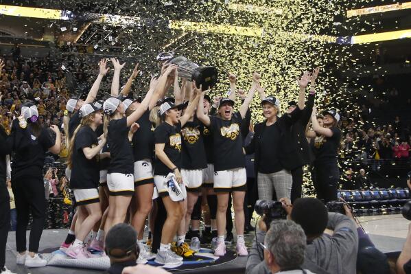 Iowa hoists the trophy after defeating Ohio State at an NCAA college basketball championship game at the Big Ten women's tournament Sunday, March 5, 2023, in Minneapolis. (AP Photo/Bruce Kluckhohn)
