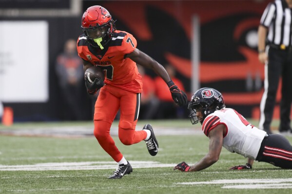 Oregon State wide receiver Silas Bolden (7) dodges Utah cornerback JaTravis Broughton (4) during the first half of an NCAA college football game Friday, Sept. 29, 2023, in Corvallis, Ore. (AP Photo/Amanda Loman)